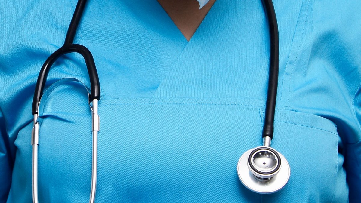 Detailed image of a medical professional wearing scrubs and a stethoscope, symbolizing healthcare.