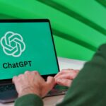 Person typing on a laptop displaying ChatGPT logo with a green vibrant setting.