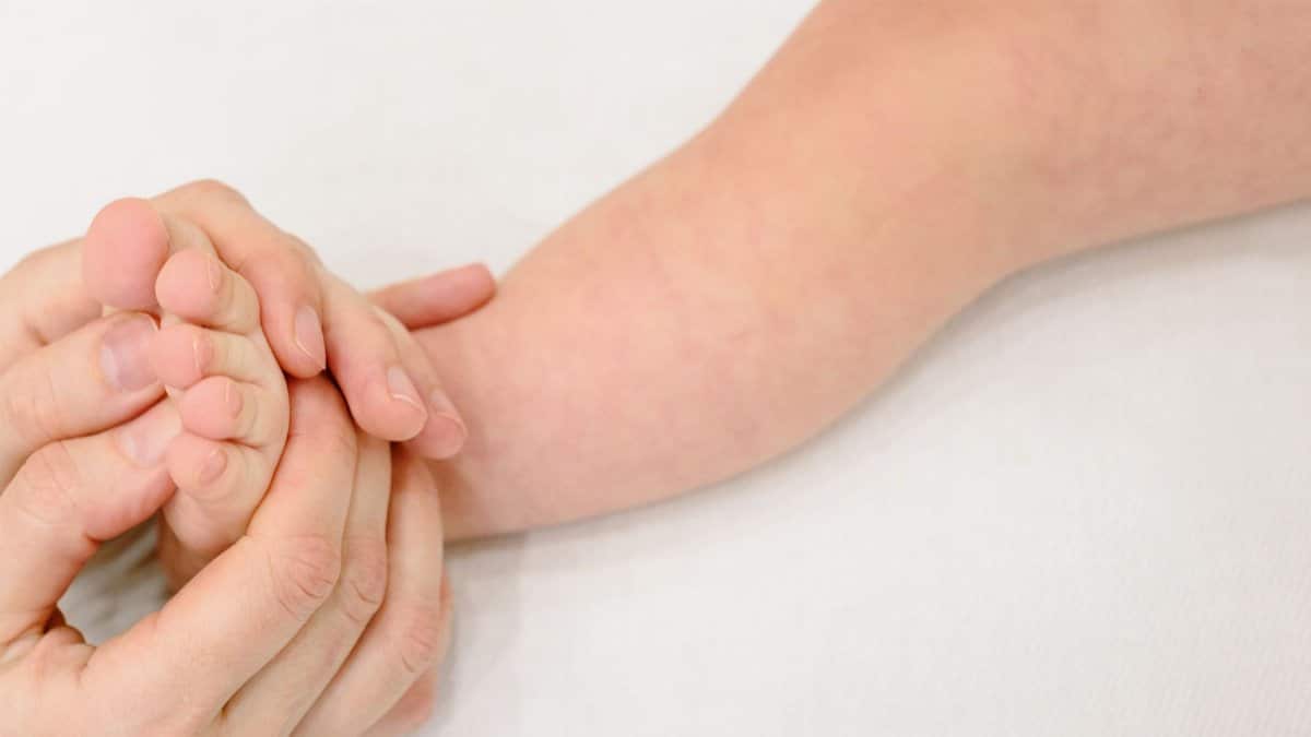 Tender infant foot massage providing soothing comfort and care.