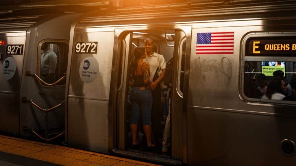 A vibrant scene of people on a New York subway train at night, showcasing city life.