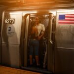 A vibrant scene of people on a New York subway train at night, showcasing city life.
