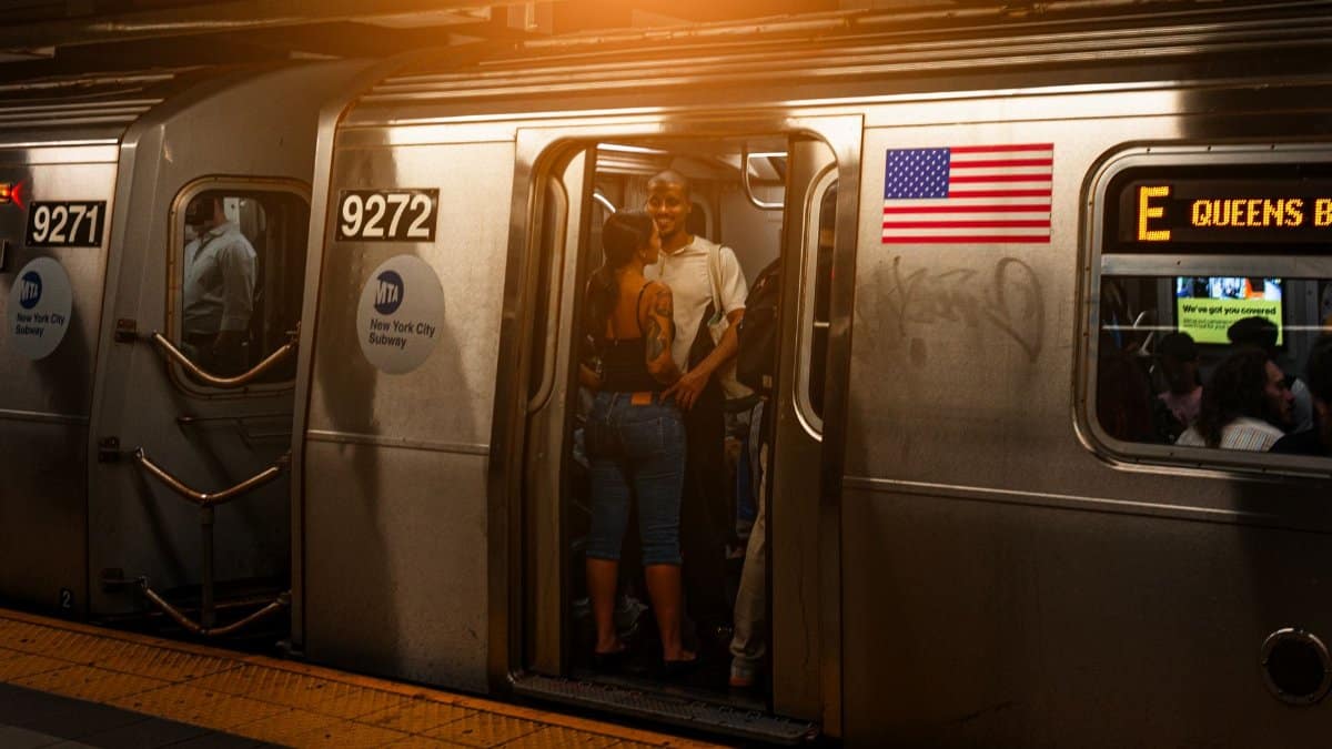 A vibrant scene of people on a New York subway train at night, showcasing city life.