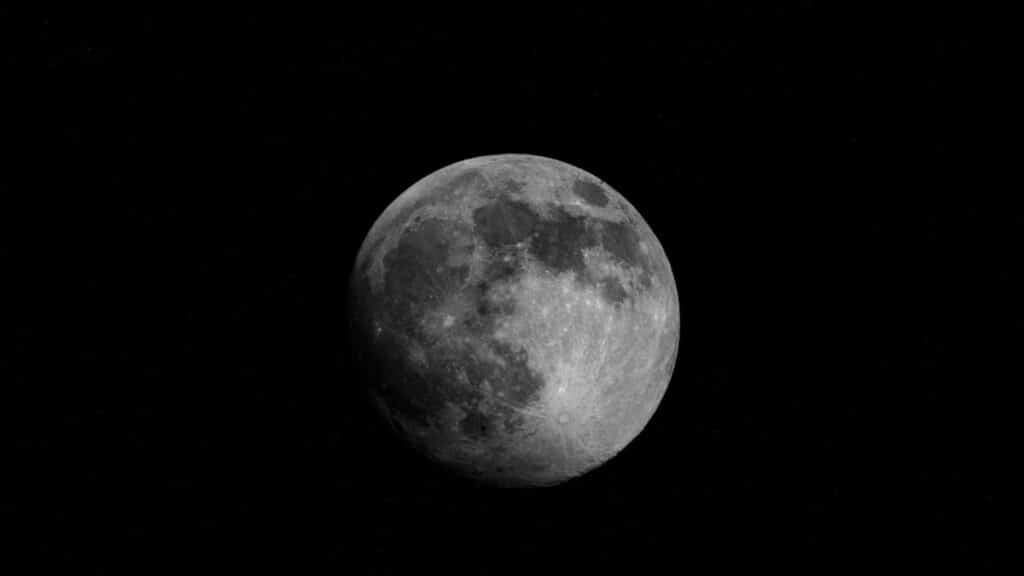 A striking image of a full moon set against a starry night sky, captured in New York, USA.