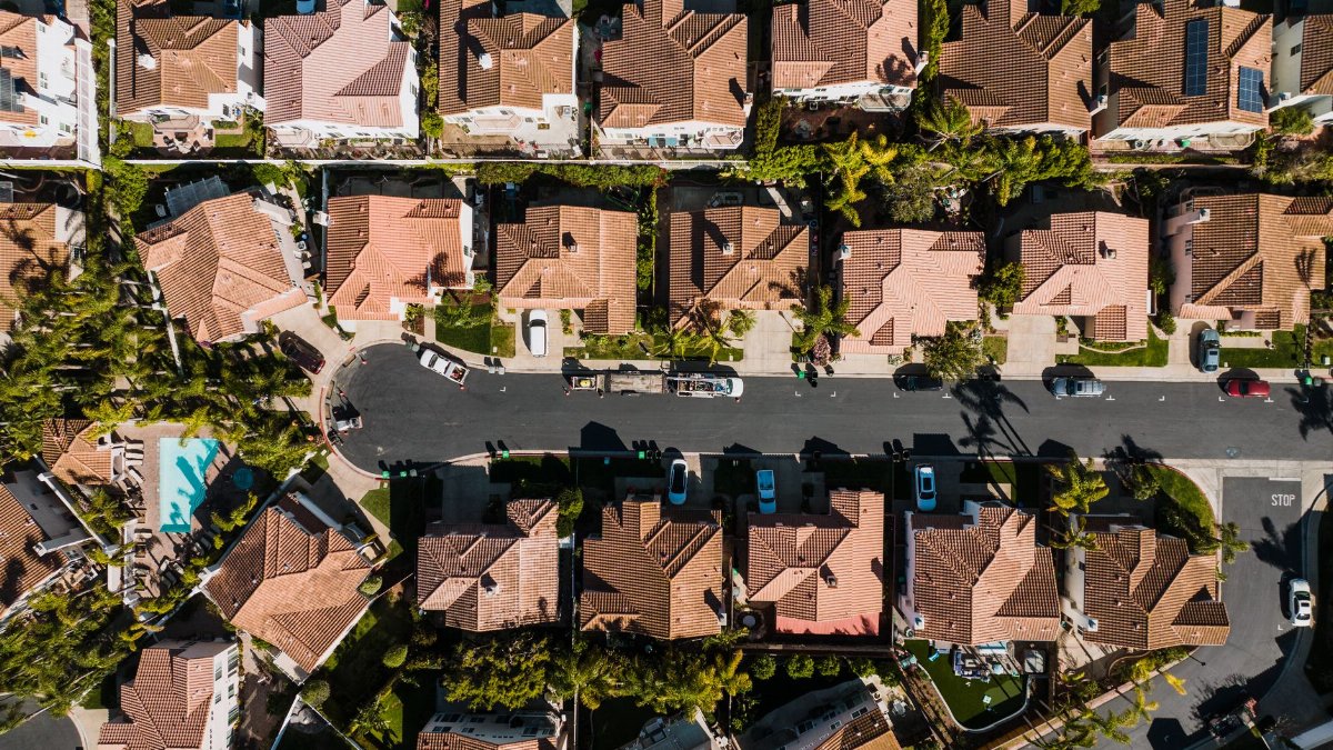 Aerial photograph showcasing a suburban neighborhood in Costa Mesa, CA, with neatly arranged houses and streets.