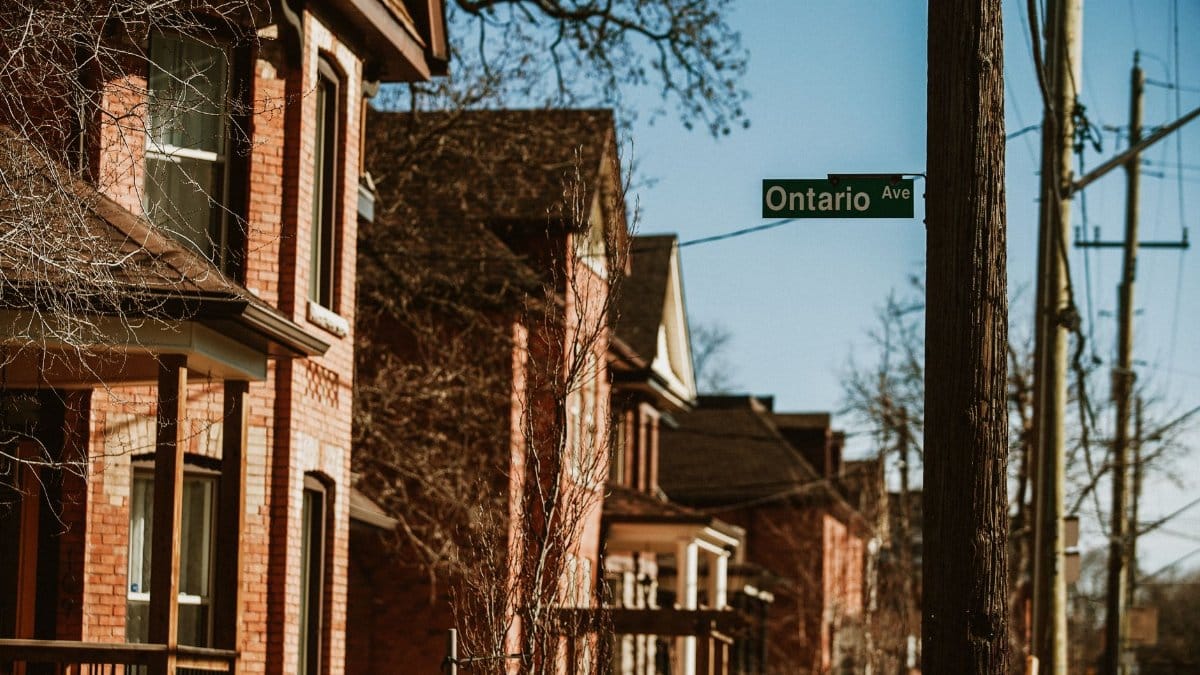 Historic brick homes on Ontario Ave in Hamilton, Canada, capturing a warm urban street scene.