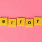 Yellow block letters spelling 'error' on a vibrant pink background, capturing a playful message.