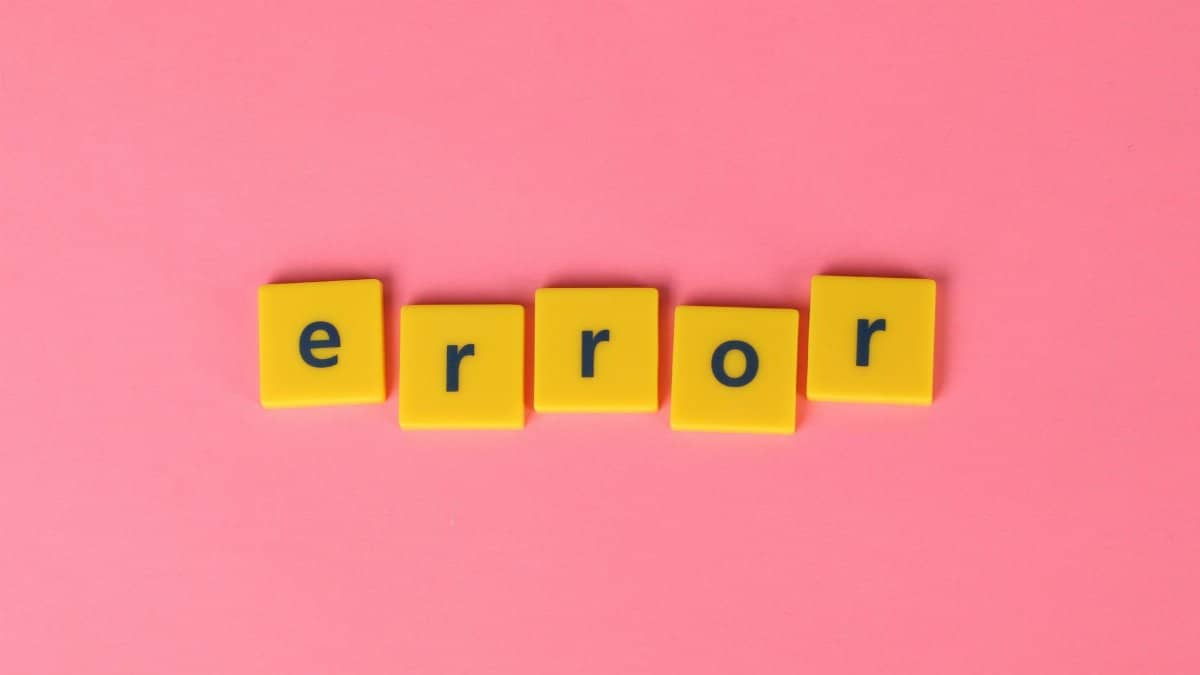Yellow block letters spelling 'error' on a vibrant pink background, capturing a playful message.