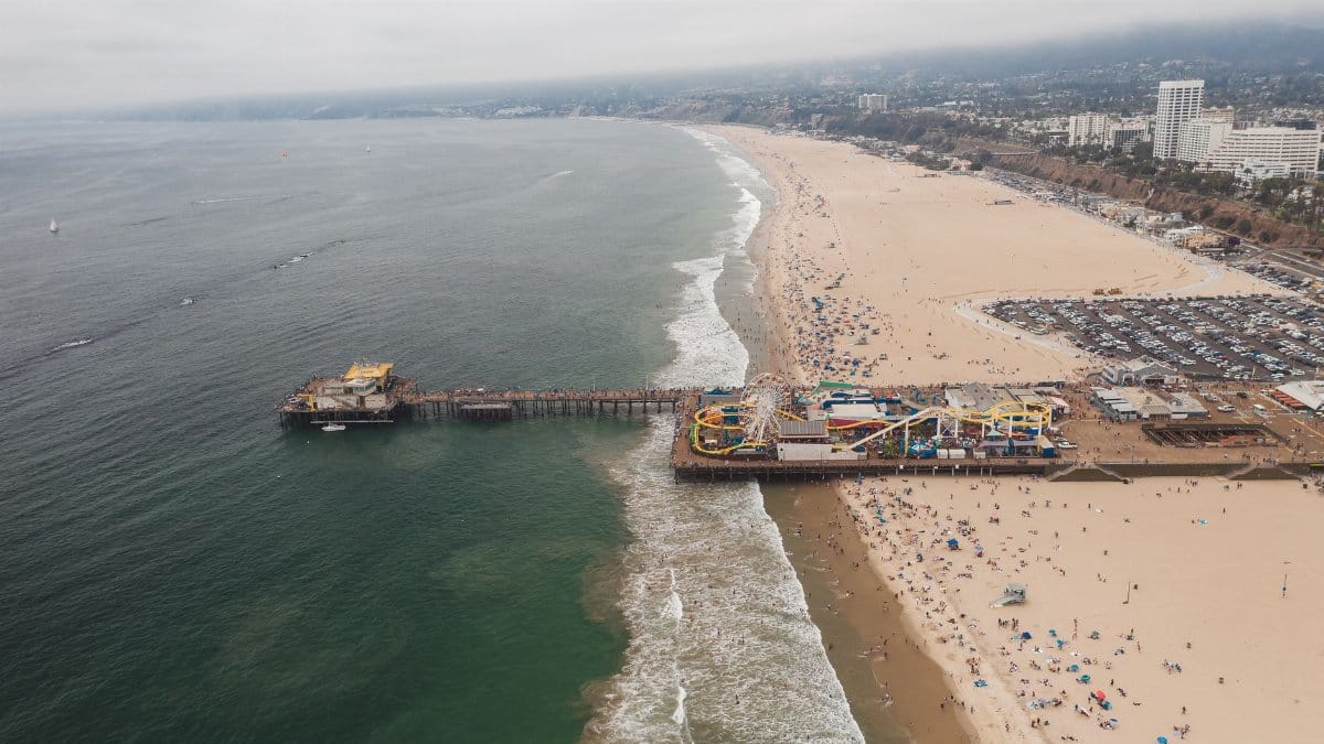 Aerial photograph of Santa Monica Pier and beach, showcasing the coastline and amusement park.