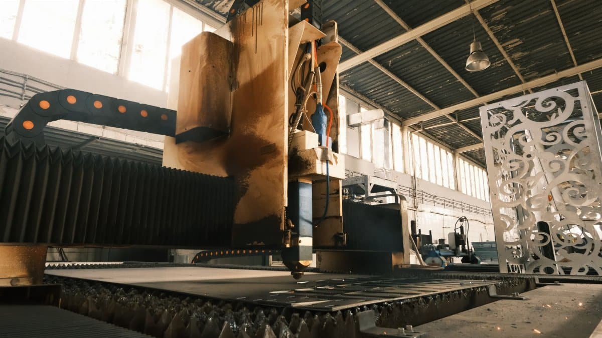 Close-up of a laser cutter in an industrial factory, showcasing modern manufacturing technology.
