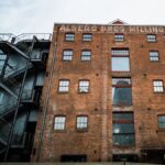 Low angle view of the Albers Bros Milling Co building, showcasing industrial charm and architectural detail.
