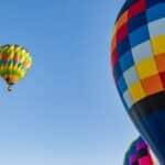 Colorful hot air balloons against a clear blue sky in Clovis, California.