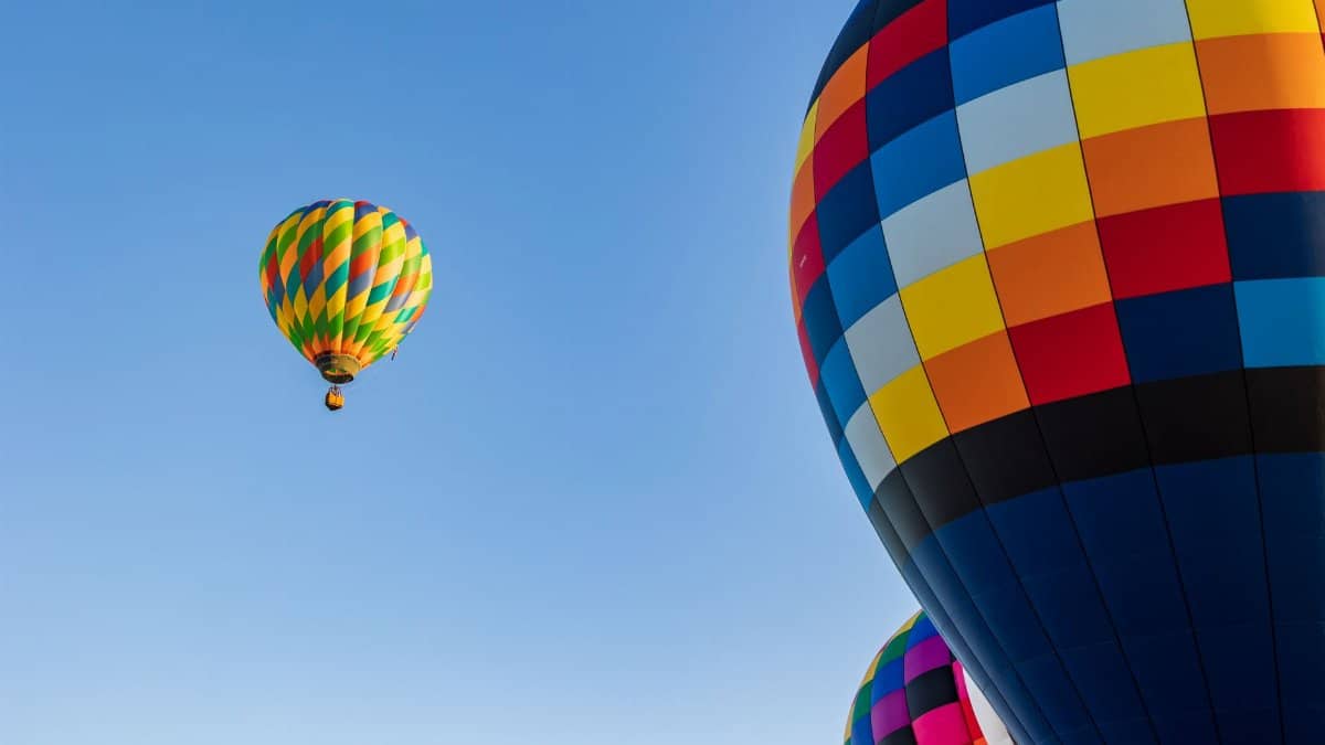 Colorful hot air balloons against a clear blue sky in Clovis, California.
