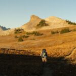 Backpackers hiking the dramatic Teton Crest Trail during autumn in Wyoming, USA.