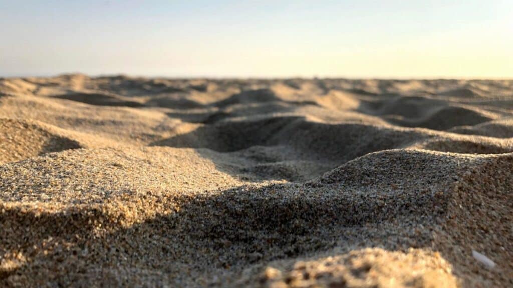 Detailed view of sand dunes at Huntington Beach showing texture and sunlight.