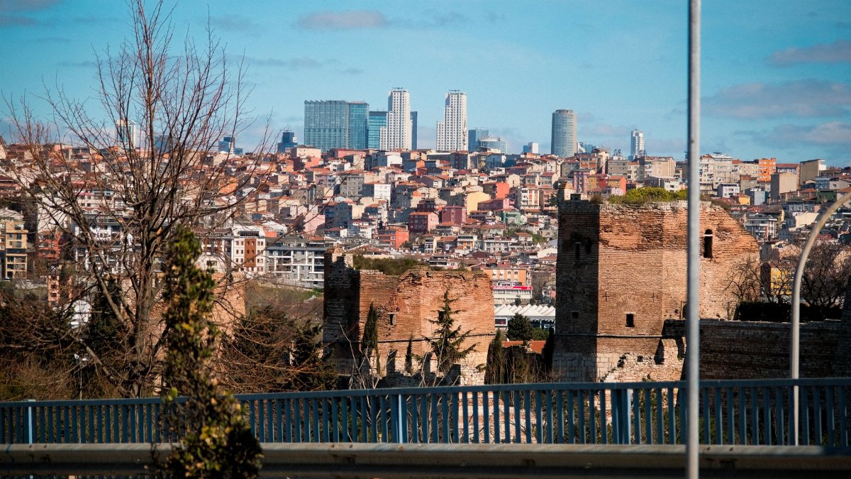 A view of Istanbul's historic walls juxtaposed against modern skyscrapers showcasing the city's architectural blend.