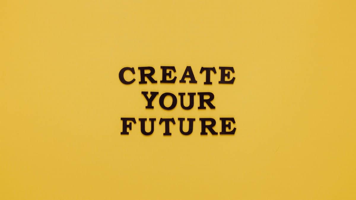 Bold text 'CREATE YOUR FUTURE' on minimalist yellow background. Inspiring design.