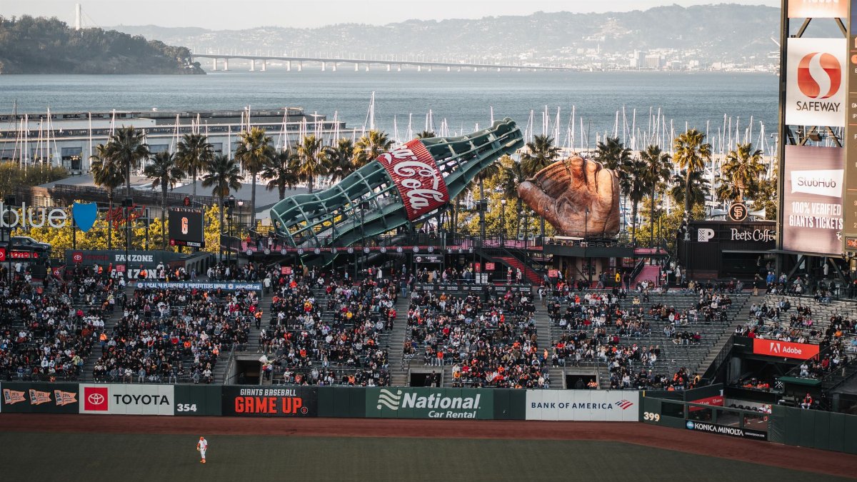 Crowd enjoys a baseball game at Oracle Park, San Francisco, with bay views.