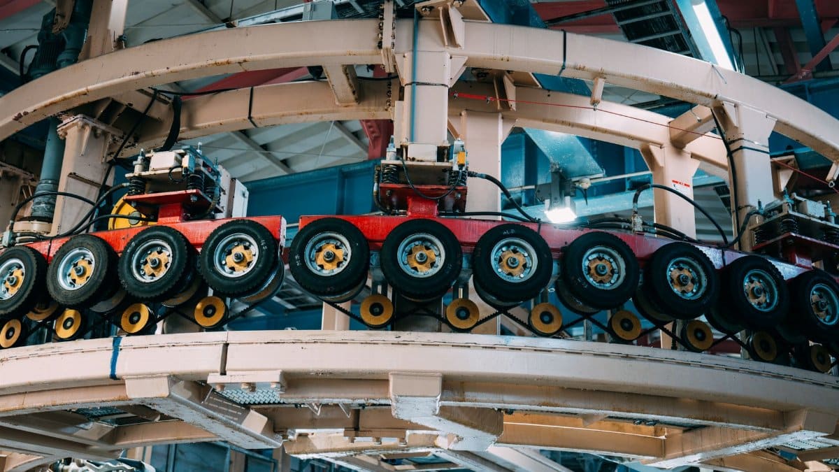 Close-up view of a complex industrial conveyor system inside a manufacturing facility.