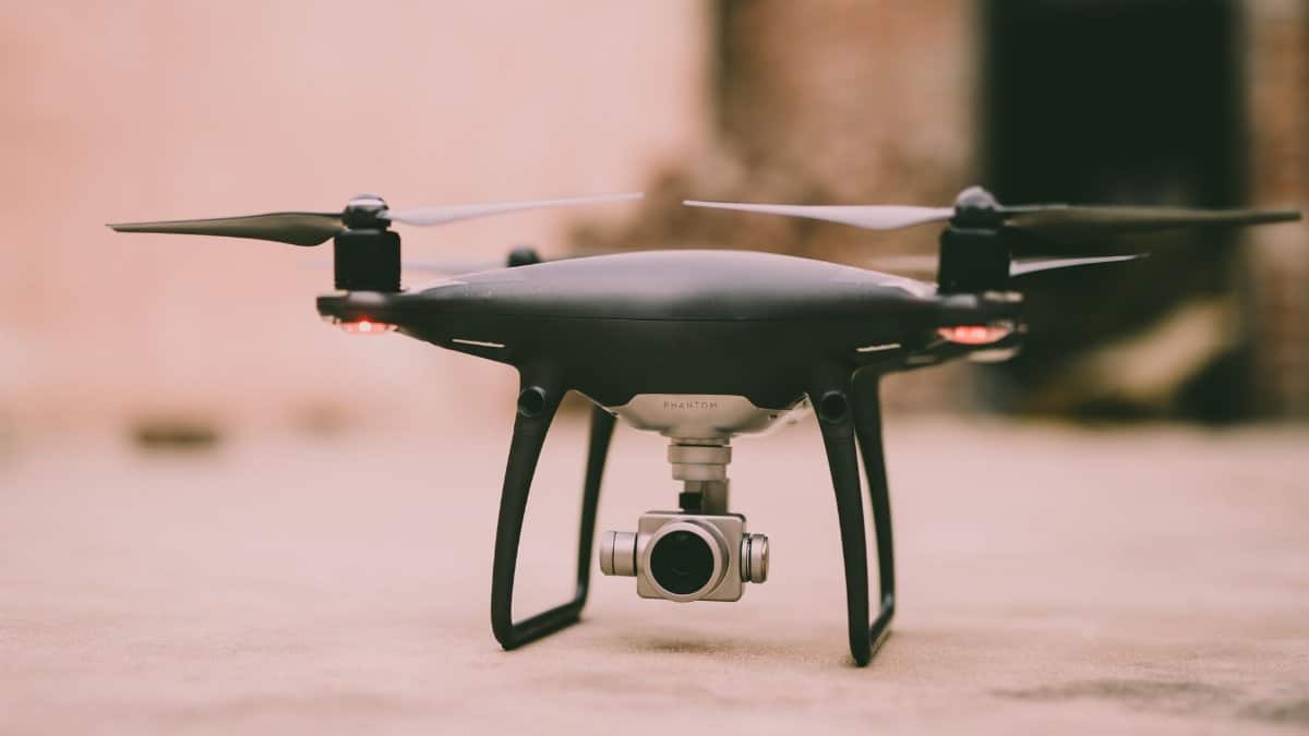 A detailed view of a Phantom drone with camera ready for flight outdoors.