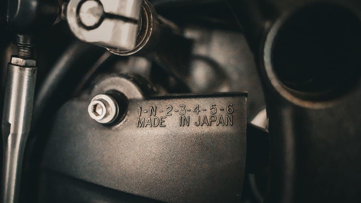 Detailed view of machinery part displaying 'Made in Japan', highlighting precision engineering.