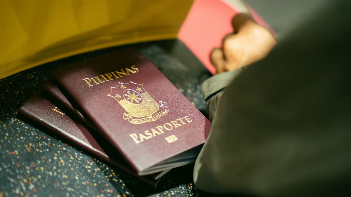 A close-up shot of Filipino passports at the airport, indicating travel and identity.