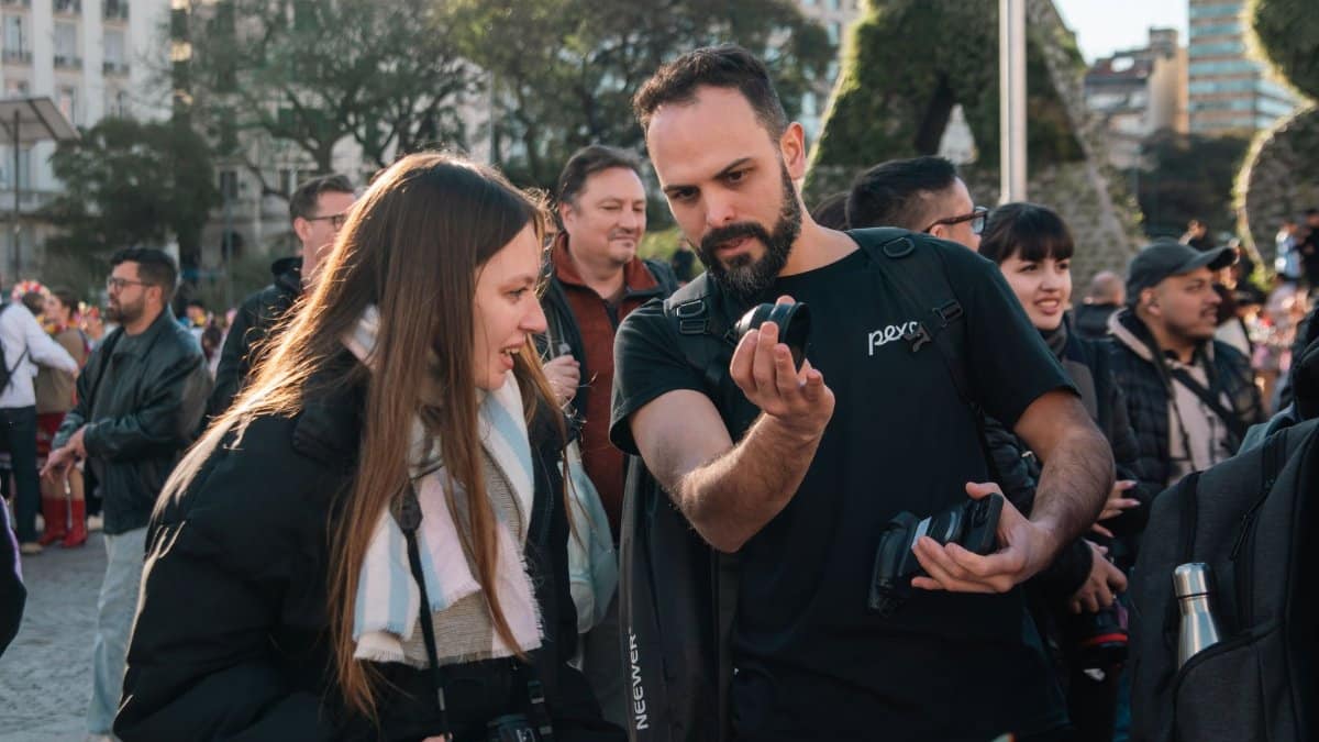 Group of photographers exchanging tips and insights during an outdoor meetup in an urban park.