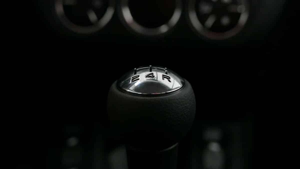 Detailed view of a manual shift knob in a vehicle, highlighting the gears.