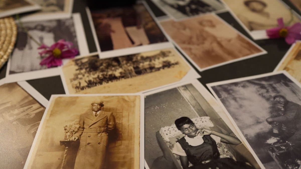 A collection of vintage sepia photographs scattered on a table, evoking nostalgia.