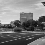 A grayscale view of Philadelphia's urban street scene featuring modern buildings and clear road markings.