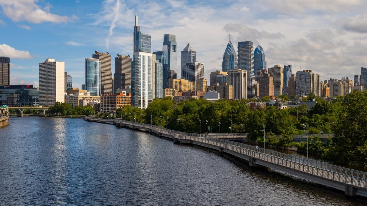Stunning view of Philadelphia skyline with the Schuylkill River in the foreground, taken on a sunny day.