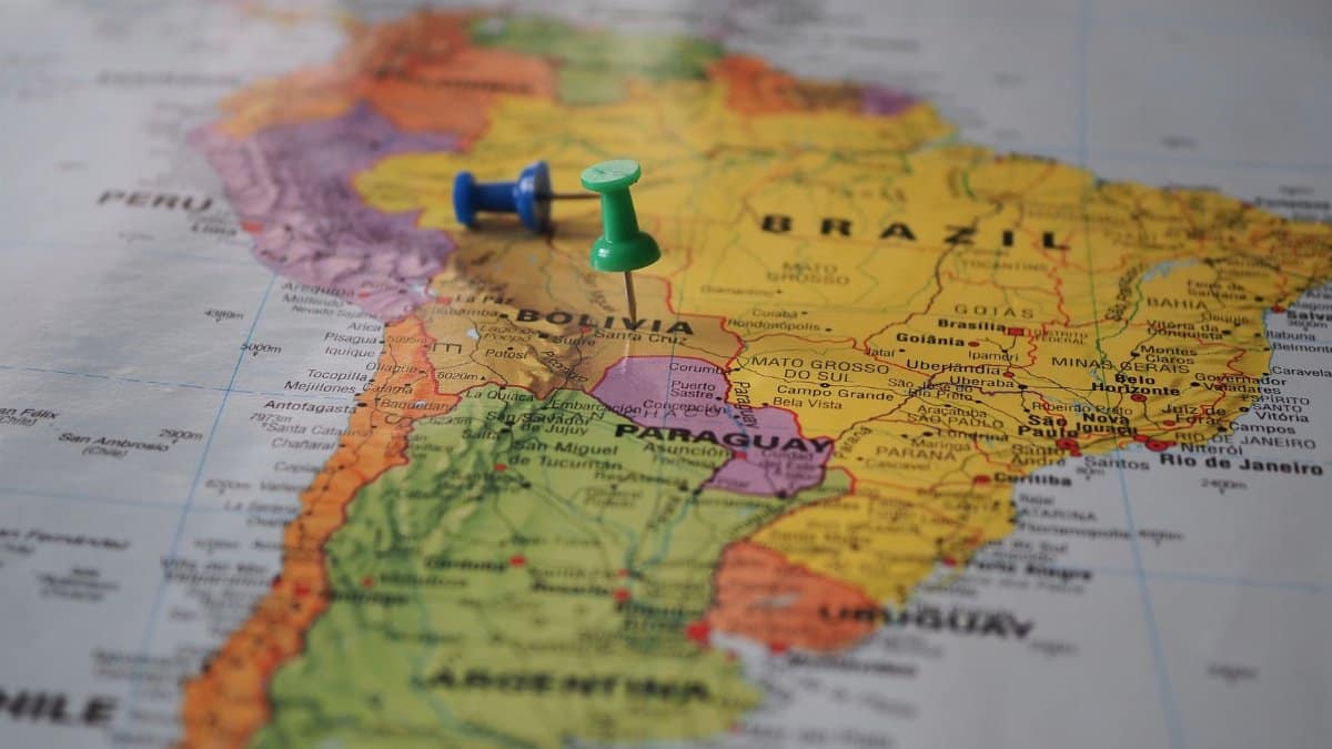 Close-up of a map of South America with pins marking locations in Brazil and Bolivia.