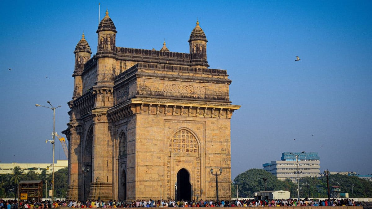 The iconic Gateway of India in Mumbai, a popular tourist attraction and historical landmark, on a sunny day.