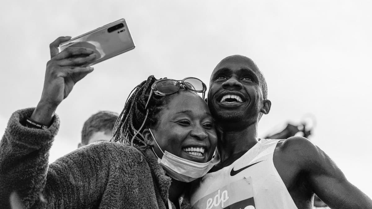A joyful moment captured in monochrome with a smiling couple taking a selfie post-race.