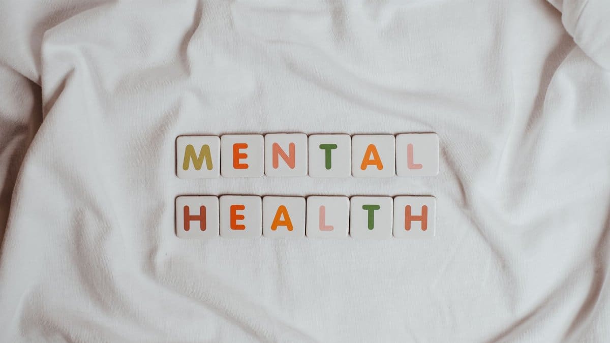 Close-up of 'Mental Health' text on cloth, symbolizing calmness and self-care.