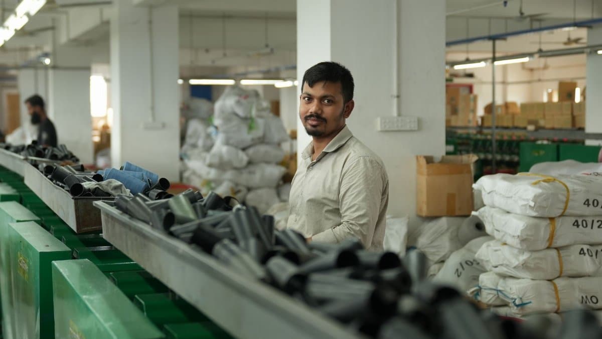 A worker in a modern factory surrounded by materials, conveying focus and industry.