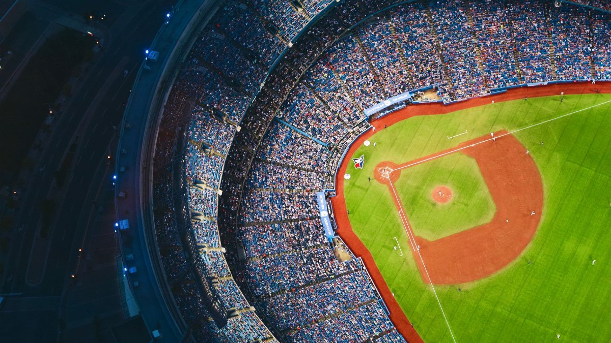 High-angle view of a crowded baseball stadium with green field in Toronto during a game.