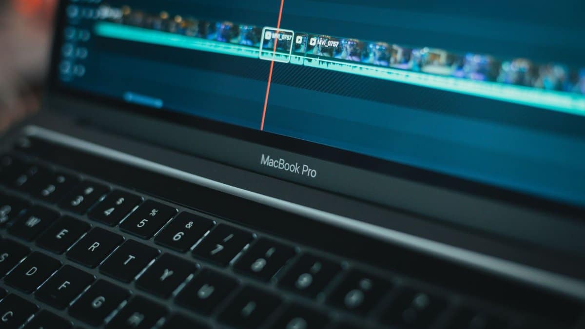 MacBook Pro with video editing software highlighting a timeline, showcasing technology in action.