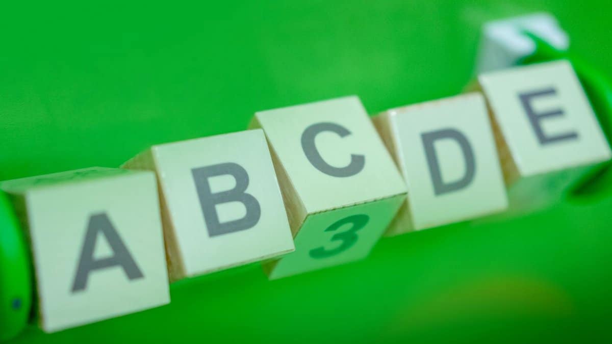 Close-up of alphabet blocks arranged with a green background, perfect for educational themes.