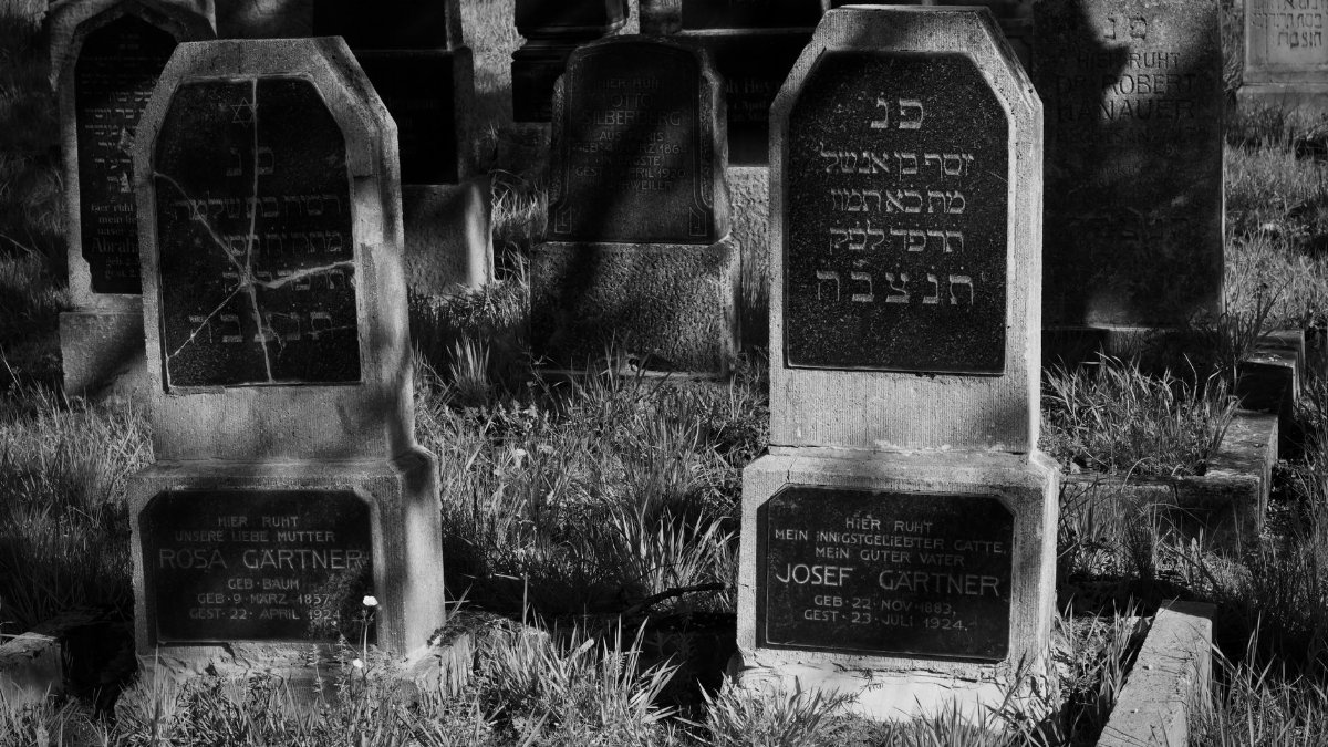 Explore the solemn beauty of old Jewish gravestones captured in monochrome, showcasing historic craftsmanship and heritage.