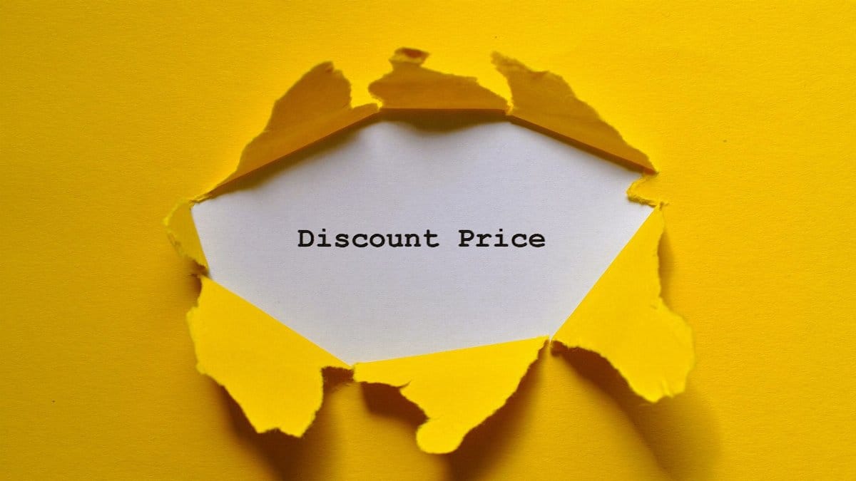 Torn yellow paper revealing 'Discount Price' text, ideal for sales promotions.