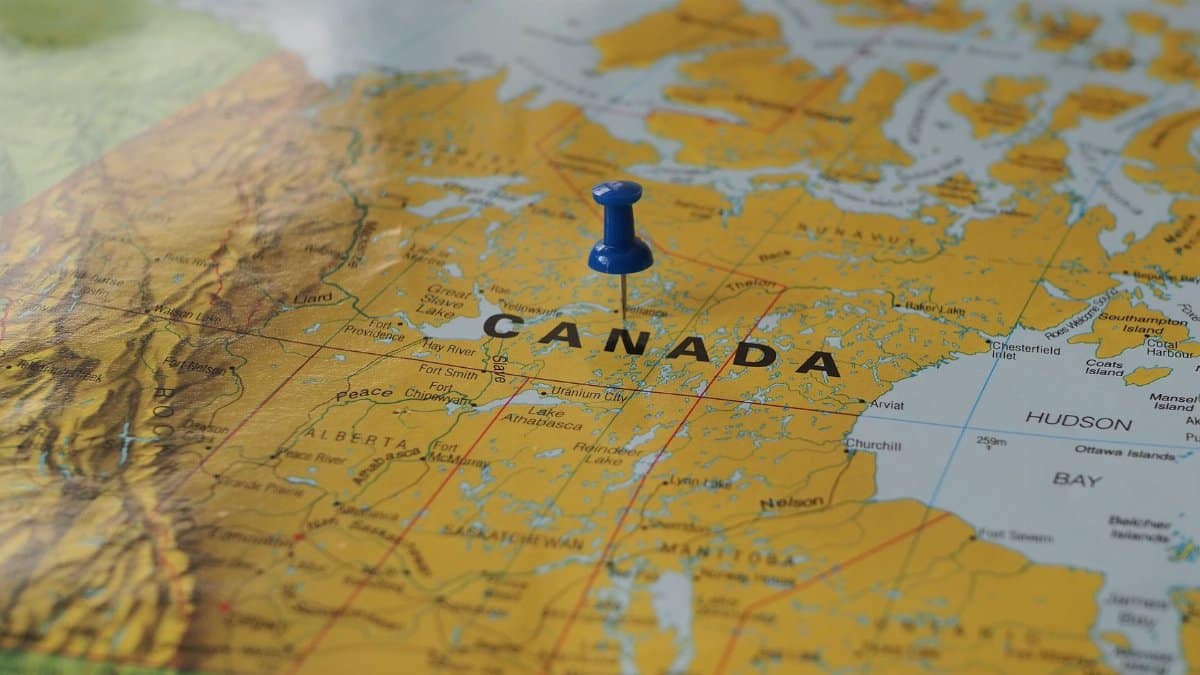Yellow map of Canada with a blue pin marking a location.