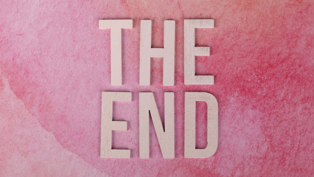 Elegant 'The End' text on a textured pink background, perfect for closure or transition concepts.