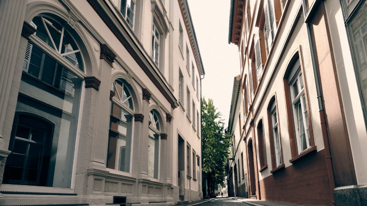 A peaceful narrow alleyway lined with historic buildings in Heidelberg, Germany.
