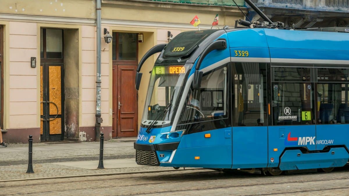 Contemporary blue tram operating in Wroclaw city, showcasing urban public transportation.