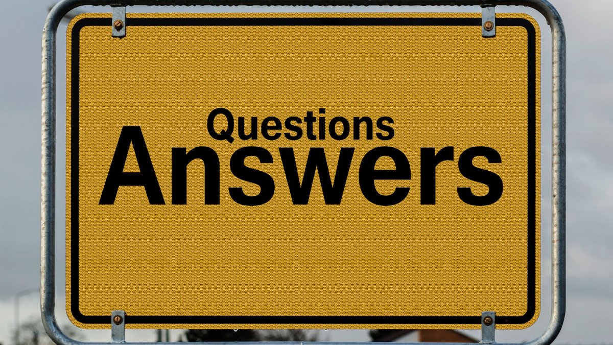 Yellow sign with text questions and answers suggesting direction in decision-making.