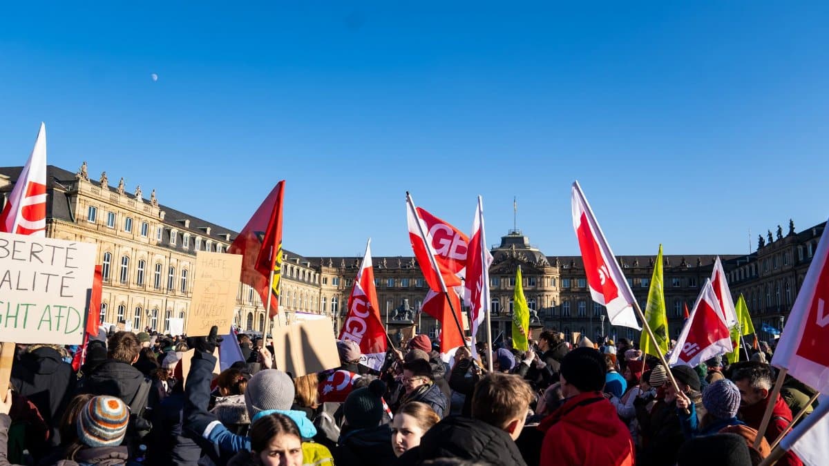 Demonstrators rally in Stuttgart against a political movement, capturing a diverse crowd and urban backdrop.