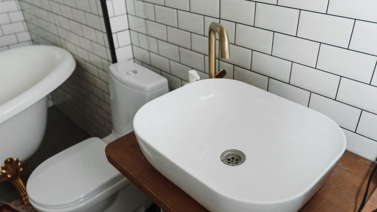 Stylish bathroom interior featuring a ceramic sink, bathtub, and modern fixtures.