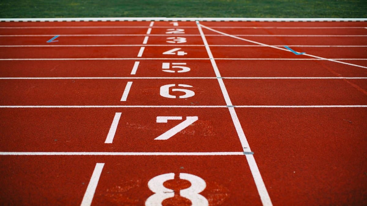 Close-up view of an athletic race track with numbered lanes, ready for competition.