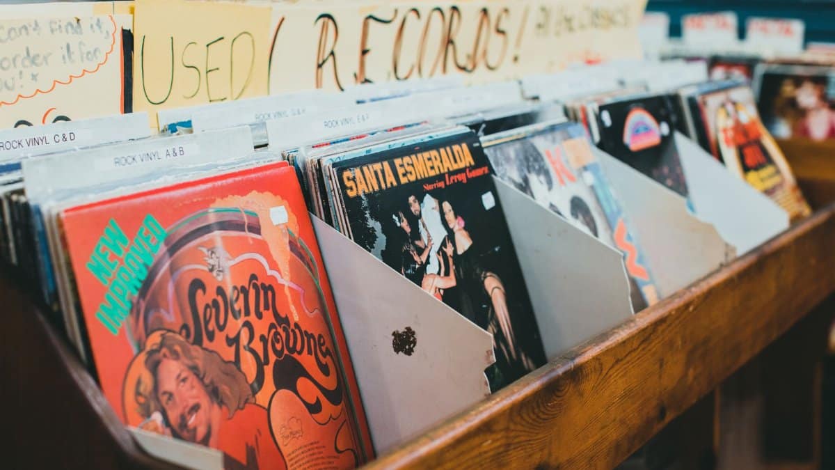 Close-up of vintage vinyl records in a music store display, emphasizing classic album covers.
