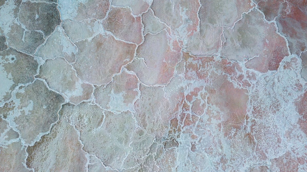 Aerial photo showcasing the unique patterns and colors of natural salt ponds.